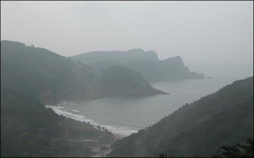 삼각산 기슭에서 내려다본 사탄동 해변, 해무가 앞을 가리지만 저 멀리 해변이 어촌 동네와 어우려져 아름답다. 